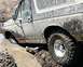 1990 Ford Bronco - This 1990 Ford Bronco is deeply stuck in thick mud, with the front wheel almost completely submerged.
