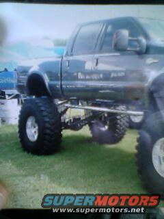 Lifted pickup truck with large tires, side view