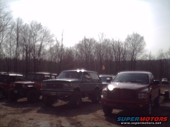 Dark green Ford Bronco with aftermarket lights on the roof, lifted suspension, and large tires