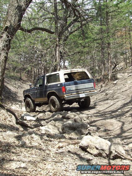 1986 Ford Bronco on rocky trail, rear view