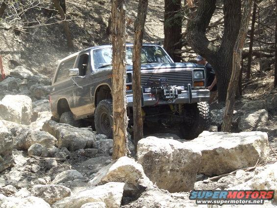 Ford Bronco going over rocks, winch on front bumper
