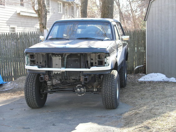1992 Ford F-150 front end with grille removed, showing radiator and suspension components