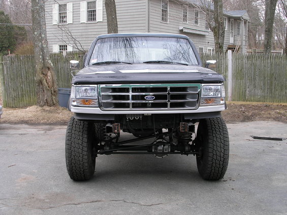 Front view of a lifted Ford F-Series truck with a chrome grille and Ford emblem