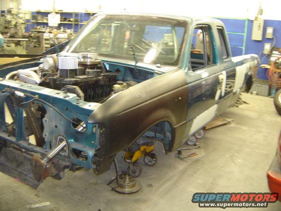 1997 Ford Ranger truck, teal and brown, engine exposed, in a workshop