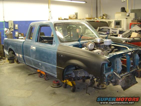 1997 Ford Ranger truck undergoing repairs in a workshop, engine exposed