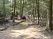 1991 Ford Bronco - Multiple off-road vehicles traverse a muddy, water-filled path through a dense forest.