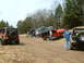 1991 Ford Bronco - A group of off-road vehicles are seen on a dirt trail, with some vehicles parked and others navigating the terrain.