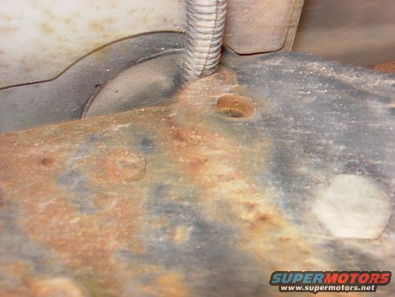 whoops.jpg so my body mount is so trashed that the entire wire loom that goes to my pass side rear tailight worked it's way in between the bushing and the frame.  Good news is I found my shorts...