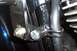 1994 Ford F-150 - Detail shot of a motorcycle engine component, a bolt and a hose clamp.