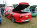 2001 Ford Fiesta - Rear view of a red ute with black racing stripes and an open lid, with a Maloo badge visible.