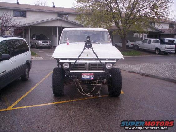 White 1978 Ford Bronco front view with chains and lifted suspension