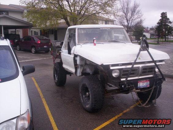 1978 Ford Bronco pickup truck modified with large tires and front-end equipment. License plate E 72188