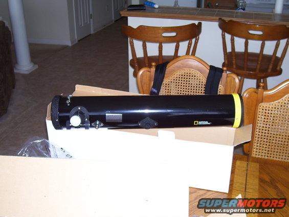 National Geographic telescope with yellow end cap, sitting in a cardboard box