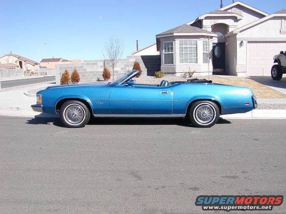 1973 Mercury Cougar convertible parked curbside in front of a suburban house