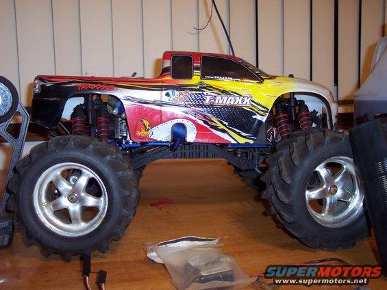 Traxxas T-Maxx remote control monster truck with colorful graphics, side view