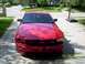 2006 Ford Mustang - A red Ford Mustang is parked in a driveway with a basketball hoop in the background.