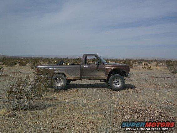 1985 Ford Ranger pickup truck parked in a desert with scrub brush