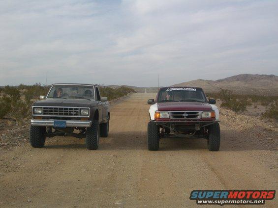 Two 1985 Ford Rangers on a dirt road, front view