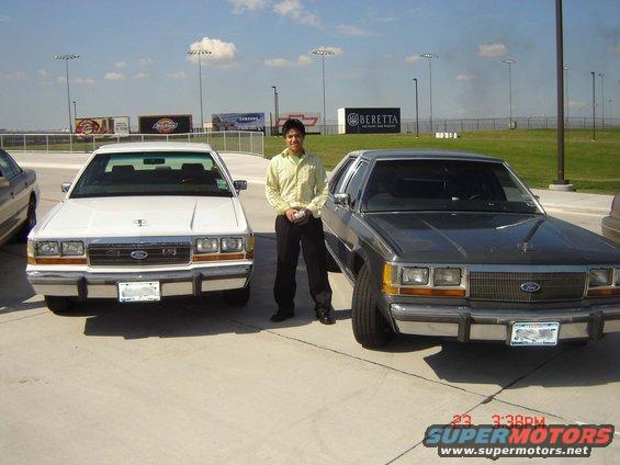 1988 Ford Crown Victoria LTD parked next to another 1988 Ford Crown Victoria LTD with a man standing between them