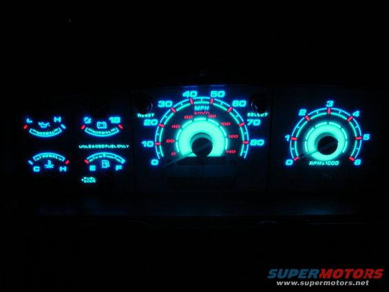 Blue glowing dashboard gauges with MPH and RPM indicators