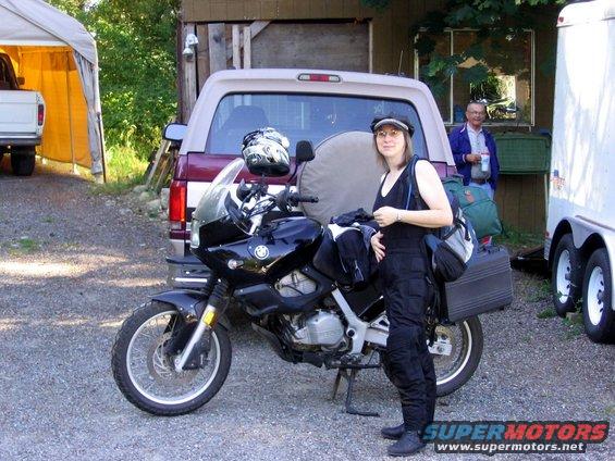 Black 1997 BMW F650 motorcycle parked beside a pickup truck