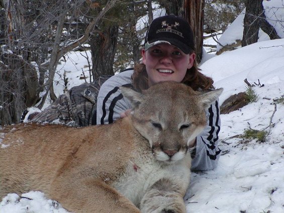 Woman in snow with a cougar