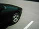 1994 Ford Probe - Front quarter panel and wheel of a black 1994 Ford Probe.