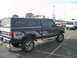 1992 Ford Ranger - A Ford Ranger pickup truck with a camper shell is parked in a lot, showing its 4x4 graphics.
