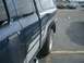 1992 Ford Ranger - A dark blue 1992 Ford Ranger pickup truck is parked in a lot, viewed from the side with a camper shell on the bed.