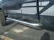 1992 Ford Ranger - The side of a dark-colored Ford Ranger STX pickup truck, showing the door and running boards.