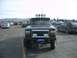 1992 Ford Ranger - A black 1992 Ford Ranger is parked in a lot, a prominent chrome grille guard and auxiliary lights on the roof.