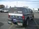 1992 Ford Ranger - This Ford pickup truck is equipped with a camper shell and mud flaps, seen from the rear in a parking lot.
