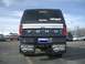 1992 Ford Ranger - Rear view of a Ford truck with a camper shell and Montana-themed mud flaps in a parking lot.
