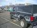 1992 Ford Ranger - Side view of a 1992 Ford Ranger pickup truck with a camper shell and 4x4 graphics.