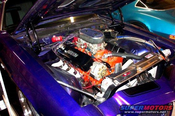 Purple 1970 Chevrolet Camaro engine bay with orange V8 engine, chrome details, and air filter