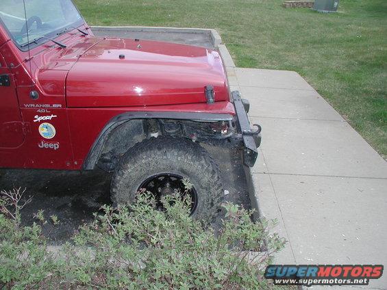 Red Jeep Wrangler 4.0L Sport with aftermarket bumper and fender flares