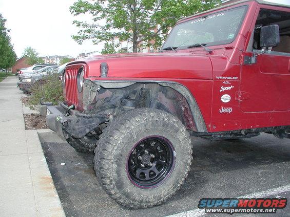Red 1998 Jeep Wrangler 4.0L Sport with damaged front bumper and fender