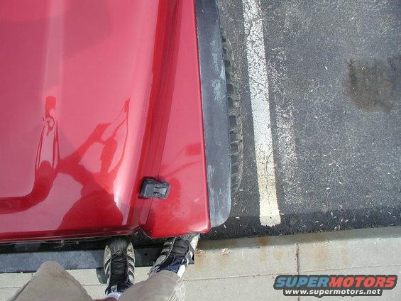 Red 1998 Jeep TJ fender and tire in parking spot