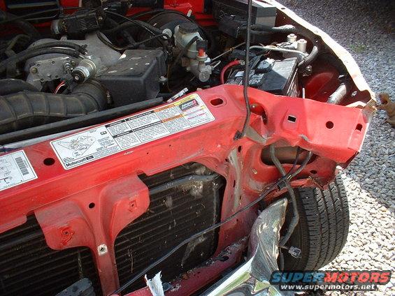 1999 Ford Ranger engine compartment with visible damage to the front fender and grille area