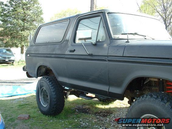Black 1978 Ford Bronco with large tires and lifted suspension