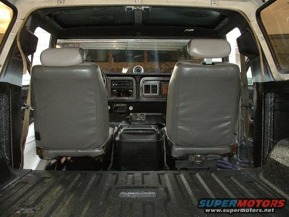Interior view of a 1978 Ford Bronco, showing front seats, dashboard, and cargo area