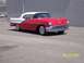 1960 Ford Falcon - A two-tone red and white convertible is shown from a three-quarter front view, parked outdoors.