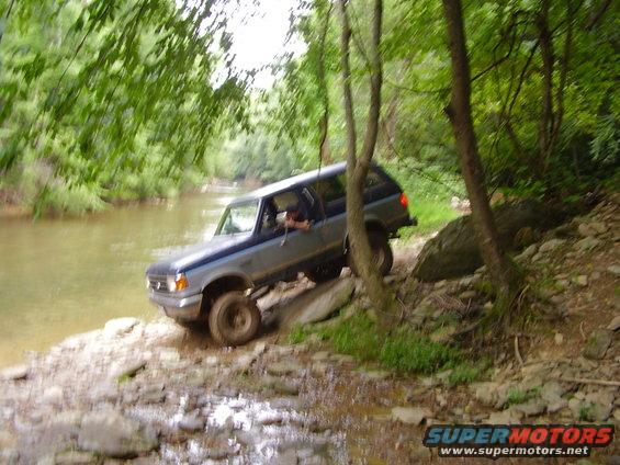1992 Ford Bronco driving off-road near water