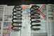 1991 Ford Crown Victoria LTD - Two used coil springs are laid out on pages of advertisements and news articles.
