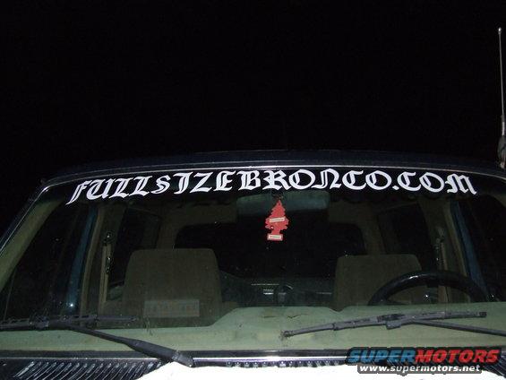 Windshield banner reads "FULLSIZEBRONCO.COM" above car interior with air freshener