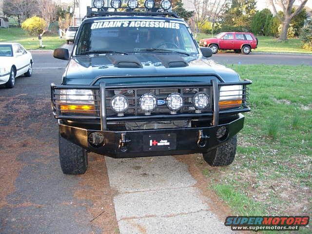 Green 1993 Ford Bronco front view with aftermarket bumper and lights