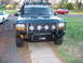 1993 Ford Bronco - This 1993 Ford Bronco features a custom front bumper with integrated lights and a roof rack.