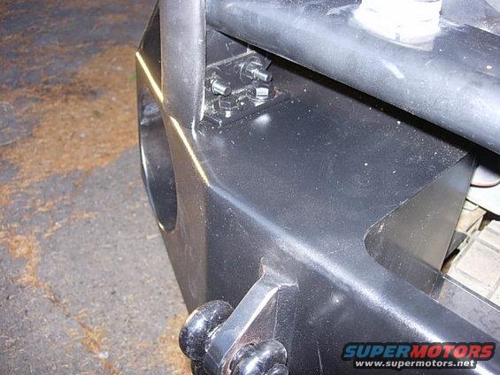 Close-up of a black aftermarket bumper with bolts and a tow hitch receiver
