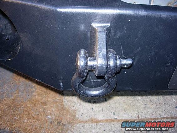 1993 Ford Bronco tow hook attached to black bumper, close-up