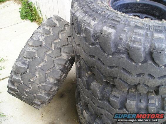 Stack of off-road tires with aggressive tread patterns